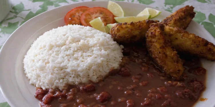 Stew Chicken Accompanied By Rice And Beans